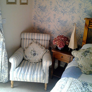 Relaxing armchair in our Bed and Breakfast blue bedroom